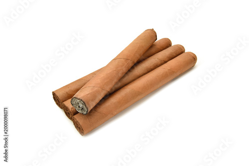 Brown tobacco long cigars in a group with burned one and grey ash closed up isolated on white