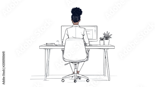 Black woman working at computer desk in office