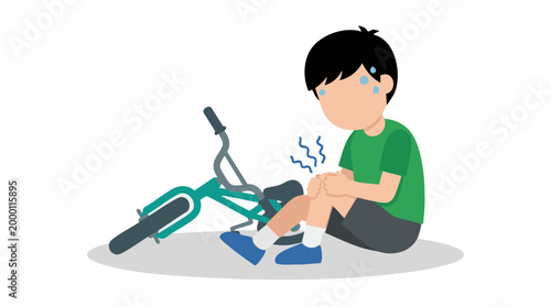 Young boy in pain on ground after falling off his bicycle