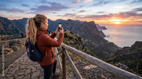 Back View of Traveler Capturing Mountain Sunset on Mobile Phone