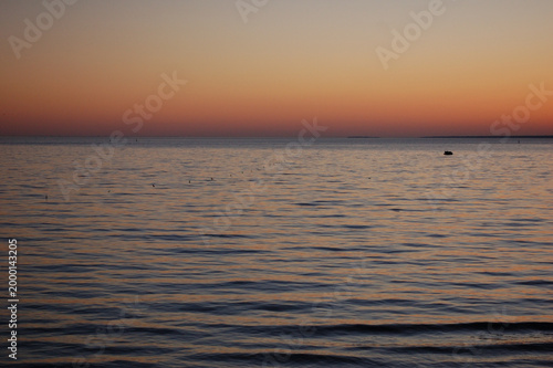 Minimal seascape with pastel sunset gradient and calm water, clean horizon background with copy space