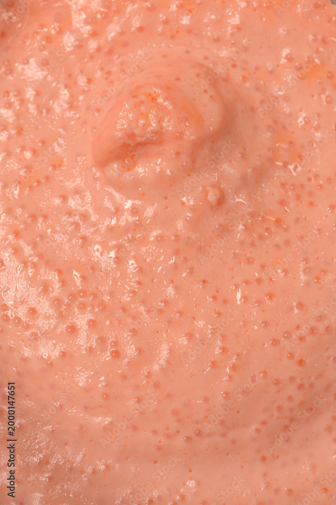 Fototapeta premium A detailed macro shot captures the creamy texture of pink fish roe spread with salmon showing small visible eggs in a close up view