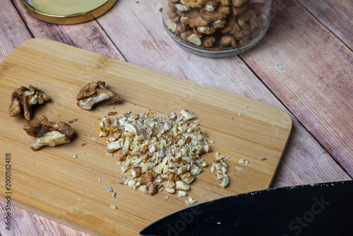 Chopped walnuts on cutting board with knife