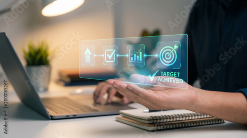 Business Success and Growth Strategy Concept with Businessman Hand Holding Holographic Interface Showing Target Achieved KPI Achievement Goal Progress Data Analytics and Future Digital Technology