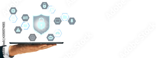 Fotografija Digital shield with lock and tech icons floating above a hand-held tablet in cle