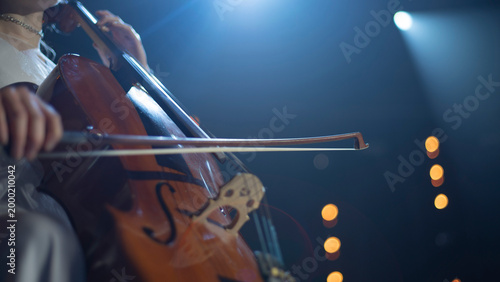 Close-up of Cellist Playing Musical Instrument on Stage with Copy Space