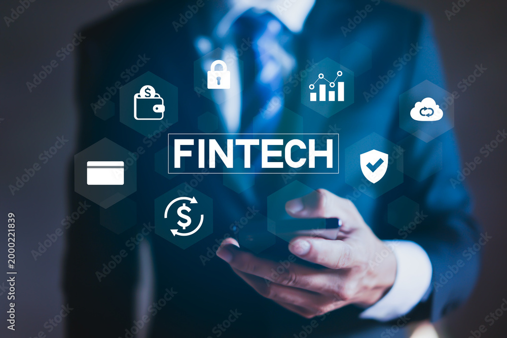 Naklejka premium Businessman using smartphone with digital fintech icons concept