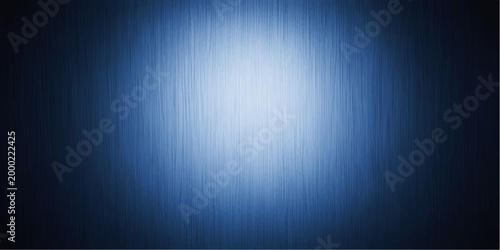 Dark blue abstract background with a spotlight reflecting on a brushed silver metallic steel plate texture for a shiny stainless material surface design
