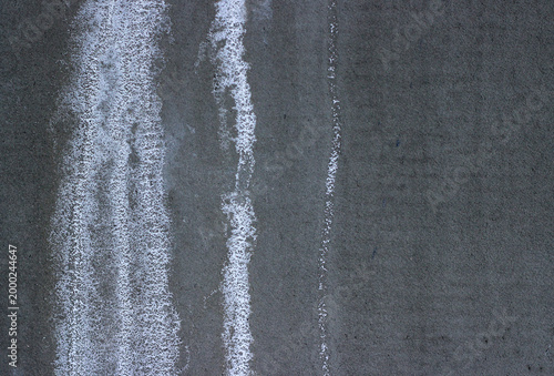 Efflorescence on concrete wall. White salt deposits and water damage texture.