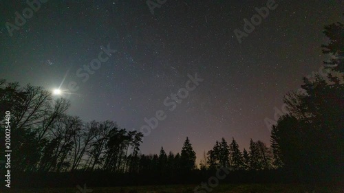 Night timelapse with moon and polar lights over forest. Landscape timelapse