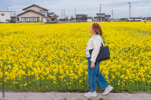 Woman Standing in a Field of Yellow Flowers