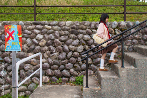 Schoolgirl Climbing Stairs Outdoors