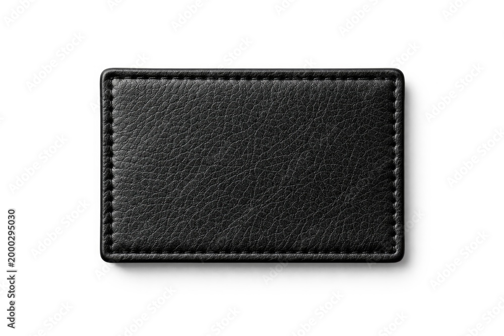 Naklejka premium Black leather patch positioned on a smooth white background featuring clipping path