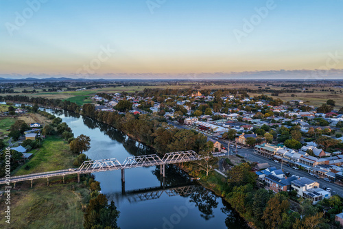 Aerial view of bridge over river and country town of Morpeth in New South Wales, Australia. Scenic rural landscape showing waterway, bridge crossing and surrounding township.