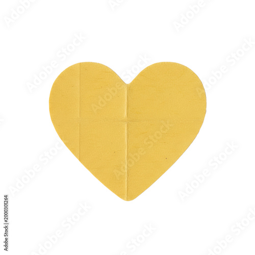 Vibrant yellow heart shaped paper sticker with visible creases and frayed edges placed on a transparent background, conveying a rustic romantic atmosphere