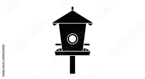 Birdhouse on a wooden post.