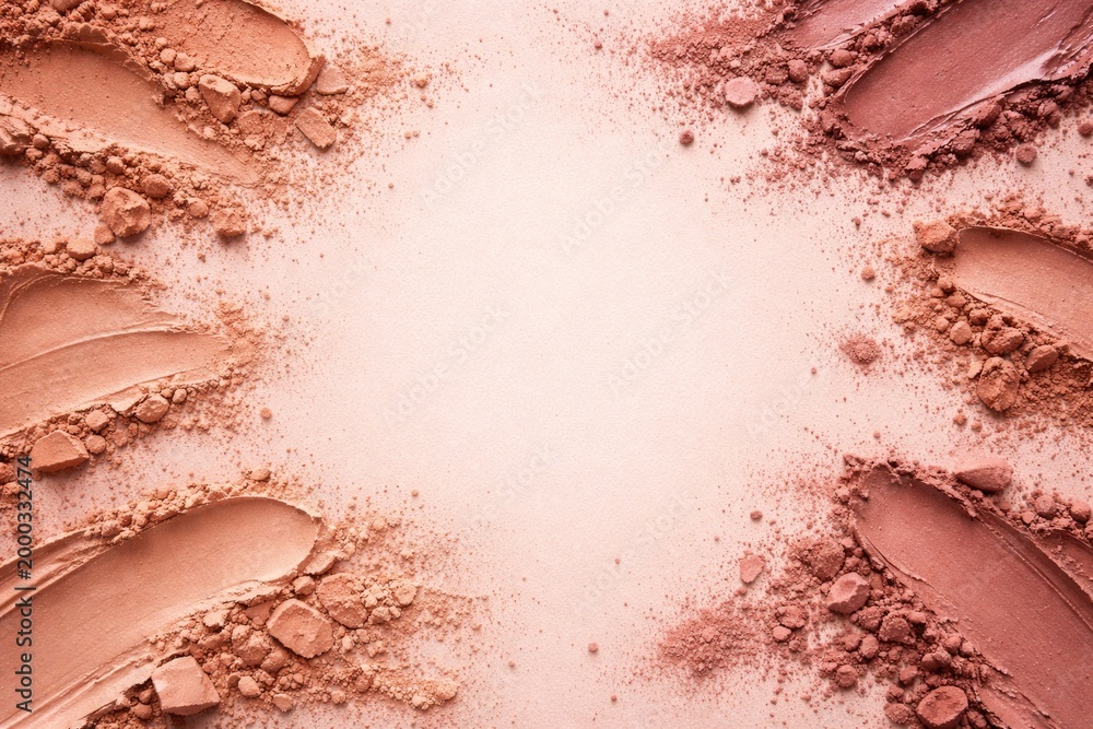Fototapeta premium lipstick powder in neutral tones spread on a gentle pink surface with free copy space for branding