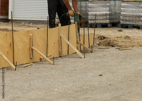 construction work on pouring concrete into wooden fortifications.