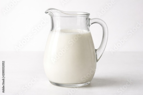 Clear image of a jug holding skim milk against a smooth white backdrop