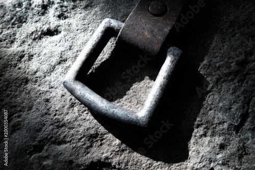 Close up of metal buckle on textured surface highlighting industrial details