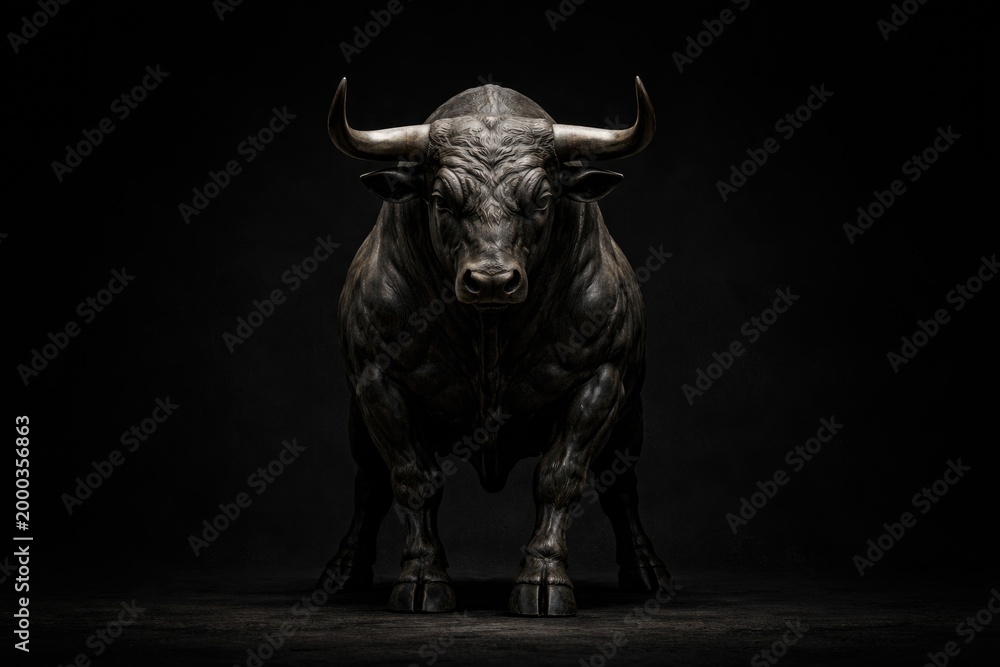 Fototapeta premium Imposing bull figure centered on a deep black canvas