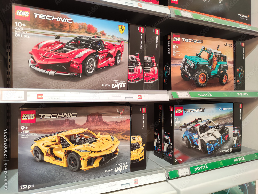 Fototapeta premium Rome, Italy - March 29, 2026: LEGO Technic building sets displayed on a store shelf, featuring Ferrari, Jeep, and sports car models with detailed packaging