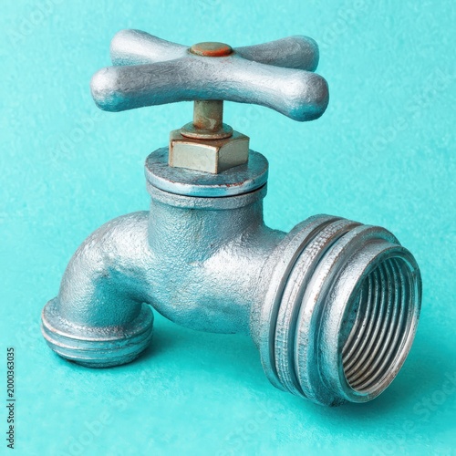 Stylish metal faucet against vibrant background featuring classic design elements and smooth finish