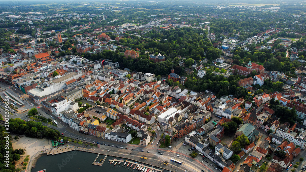 Fototapeta premium Aerial view around the old town of the city Flensburg in Germany on a sunny spring noon