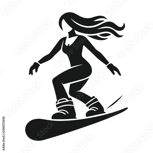 Snowboarder carving down the mountain enjoying winter sports.