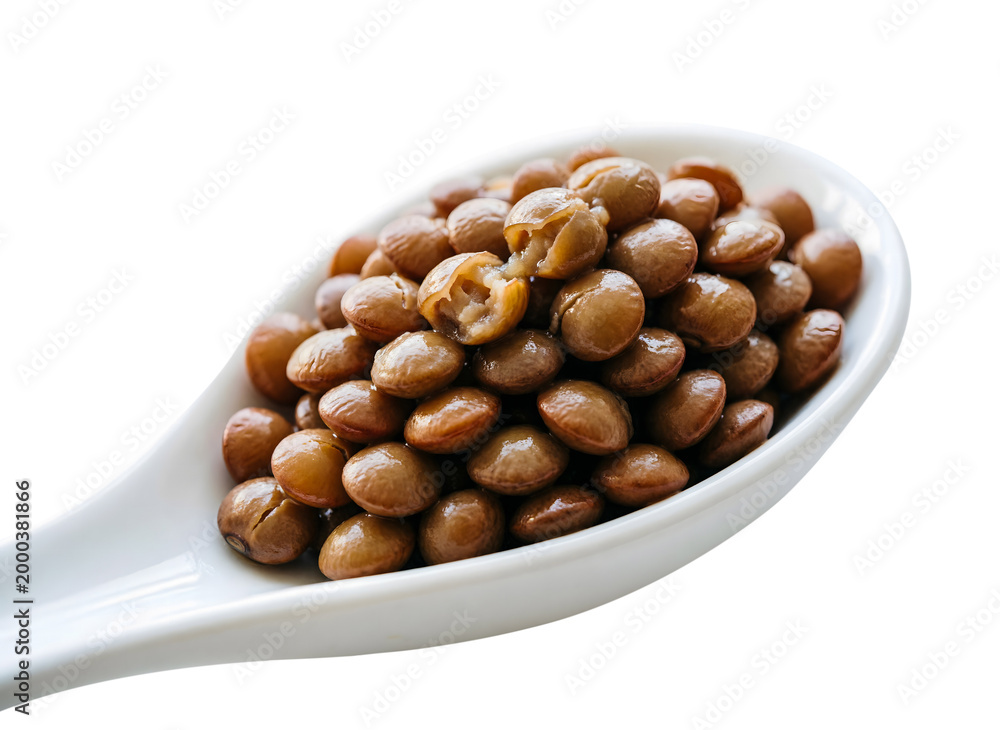 Obraz premium Cooked Brown Lentils in a White Ceramic Spoon, Macro Detail Isolated on a Pure White Background.
