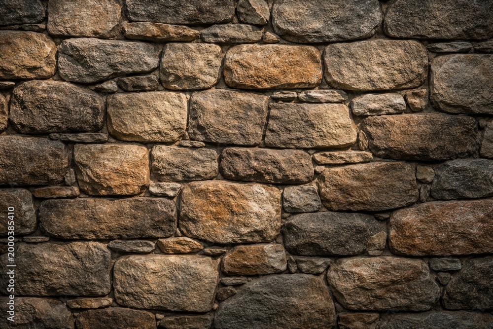 Fototapeta premium Natural stone wall texture background with subtle shadow effects
