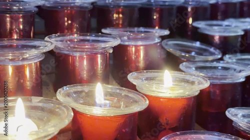 Close up of burning red votive candles