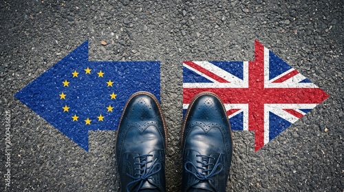 Business professional stepping on EU and UK flags symbolizing Brexit decision and international relations