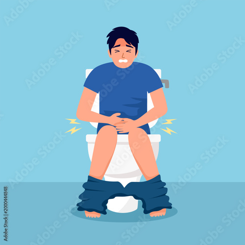 Man sitting on a toilet and clutching his stomach, suffering from constipation, pain, and digestive system problems