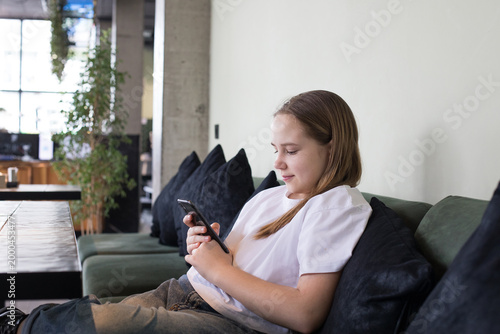 Photography Cheerful preteen child holding mobile cell phone