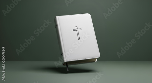 White Christian Holy Bible with black cross emblem floating against minimalist dark green background, sacred scripture, religious faith concept, modern spiritual literature.