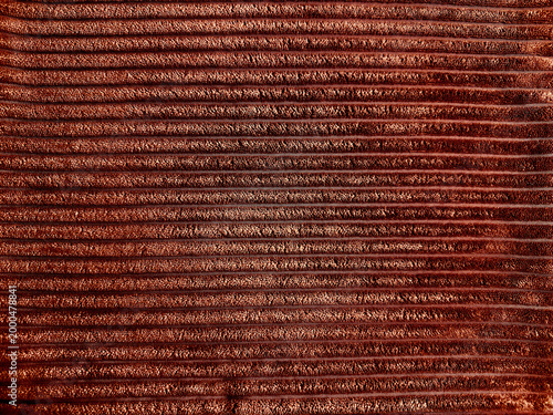 textured rust brown corduroy fabric rib knit velvet surface detail shot