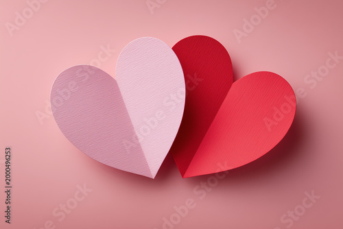 Pink and red paper hearts, love concept, paper cut background