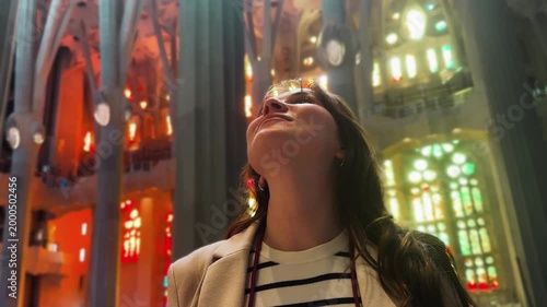 A tourist inside a museum or historical building looks around and admires the architecture. High quality 4k footage