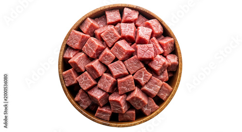 Raw beef cubes in wooden bowl