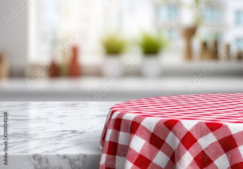 A close-up view showcases a checkered tablecloth draped over a marble tabletop, with a blurred kitchen background.