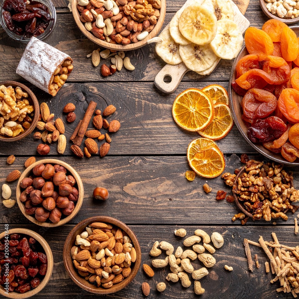 Fototapeta premium Assorted dried fruits and nuts on wooden table.