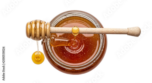 honey in glass jar with wooden dipper
