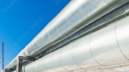 close-up of a pipeline against a blue sky