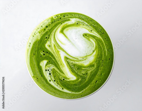 Concentric ripple of green matcha liquid on white milk surface, top down tea latte impact isolated on white