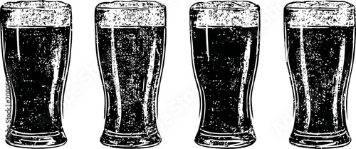 Four dark beer pints lined up with frothy foam on top in a row on white background