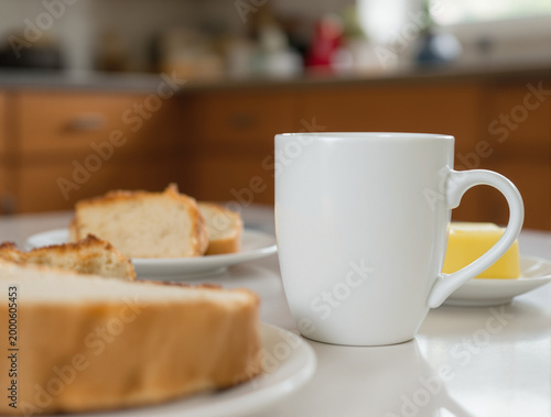 White mug with bread on table