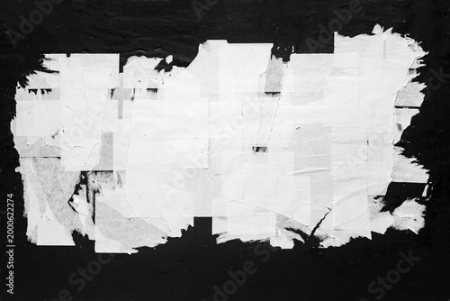 Old torn city poster on a black wall