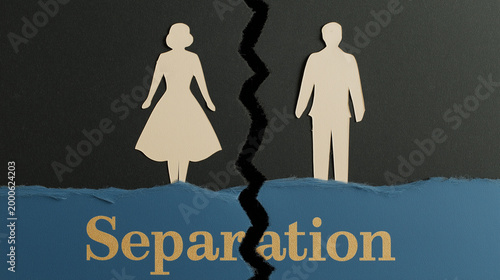 Paper cutout of woman and man separated by a jagged line on dark background. Divorce concept illustrating relationship breakdown, conflict, legal dissolution of marriage and social split.