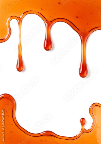 Honey or maple syrup drips isolated on white background
